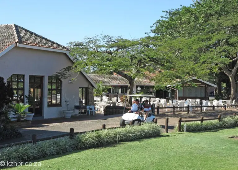 Port Shepstone Country Club golf cart driving by clubhouse