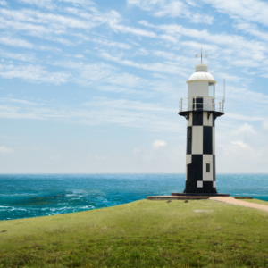 Port Shepstone lighthouse black and white building with sea in background