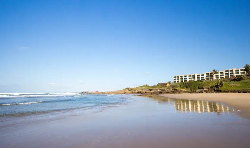 Uvongo beach with waves and building in background kzn south coast