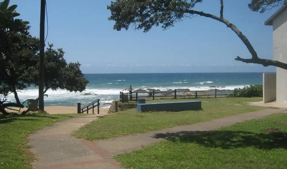 Southport Beach KZN South Coast path through grassed area to beach with blue sea